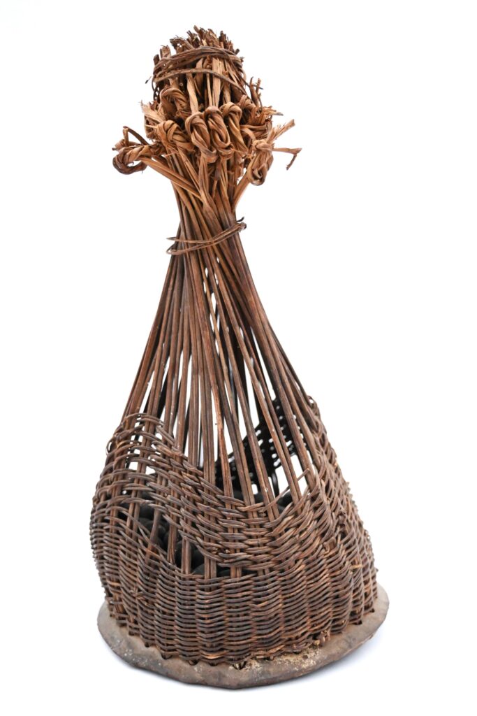 Rattle with exterior resembling a cone shaped basket