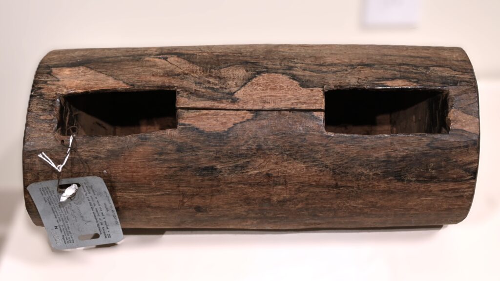 Log with two holes forming a slit drum
