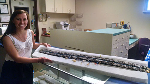 Shannon poses with the belt after successfully defending her thesis.